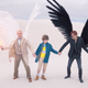Aziraphale the angel and Crowley the demon holding hands with the Anti Christ.